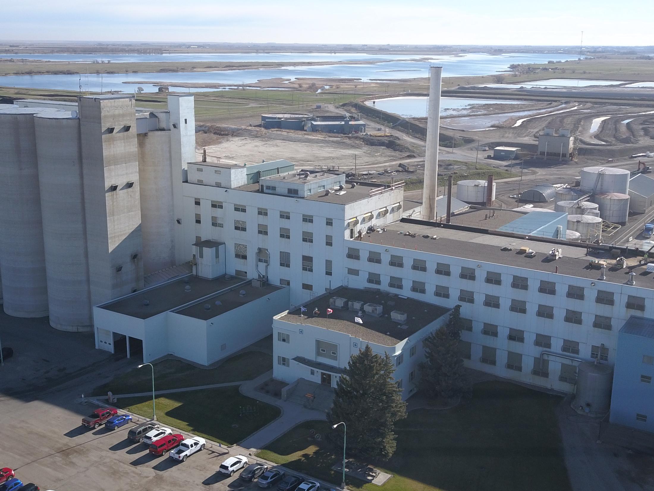 A drone photograph looking down onto the roofs of an industrial plant in southern Alberta